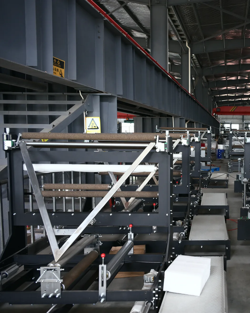 Machine frames under assembly in the workshop, overhead crane above