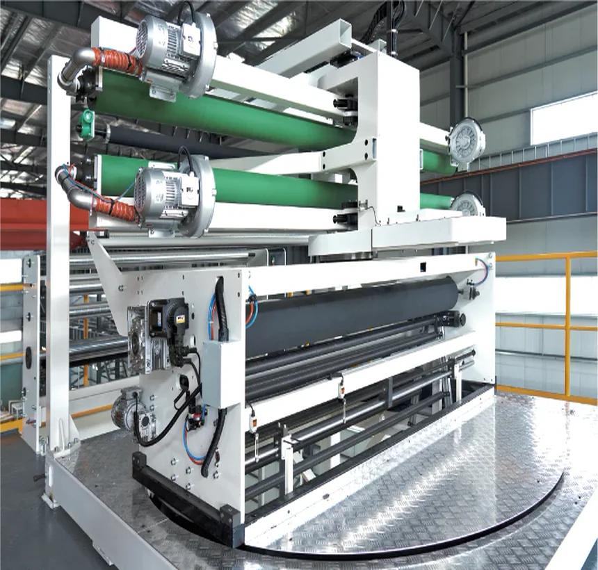 Horizontal rotating haul-off unit on its turntable, green idler rollers and drive motors on the frame above